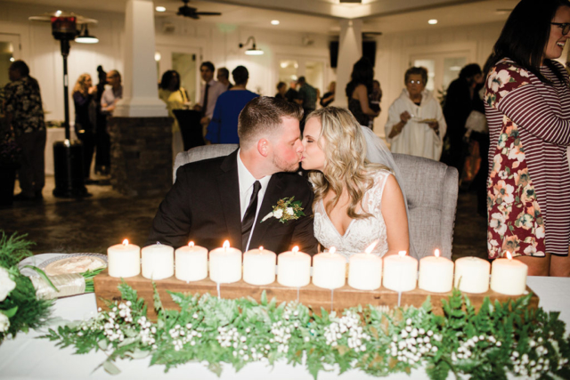 Ashlyn + Brock Harrell wedding Oak Meadow kissing reception candles