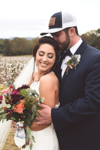 Jordan + Jordan Moore wedding couple kissing in front of cotton field