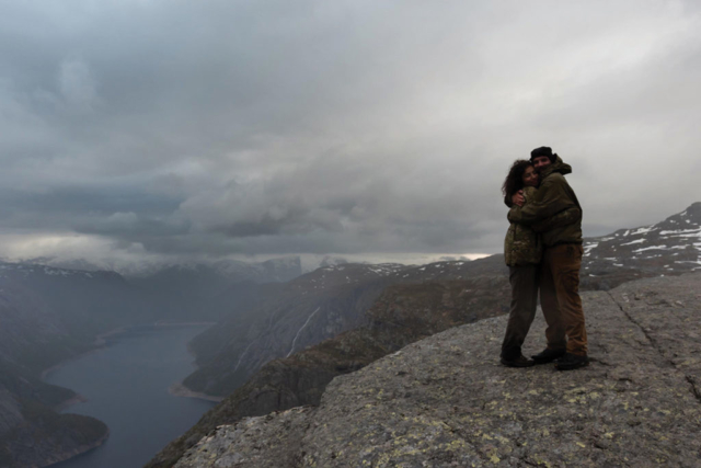 thomas + megan engaged hugging top of mountain hiking