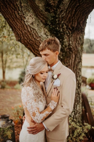 Kaylan-Chris-wedding portrait embracing by tree