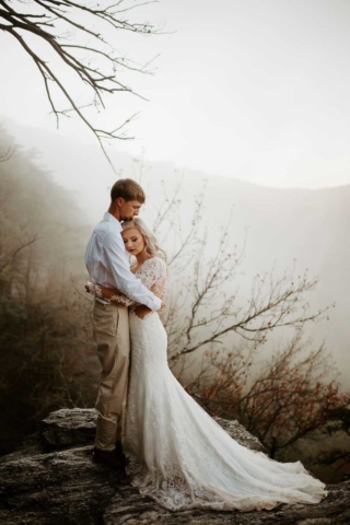 Kaylan-Chris-wedding portrait on clif Cheaha Mountain sunrise fog