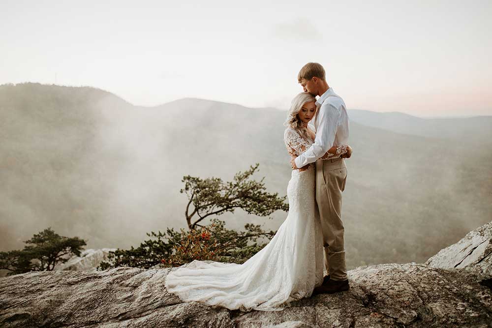 Kaylan-Chris-Alabama wedding portrait on clif Cheaha Mountain sunrise fog