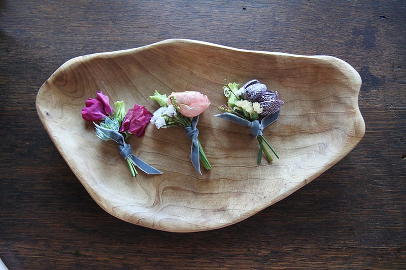 small fresh wedding flower bouquets in hand carved wood dish
