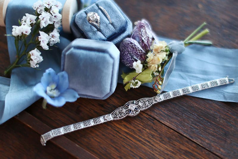wedding bands in soft blue velvet ring box with vintage silver bracelet