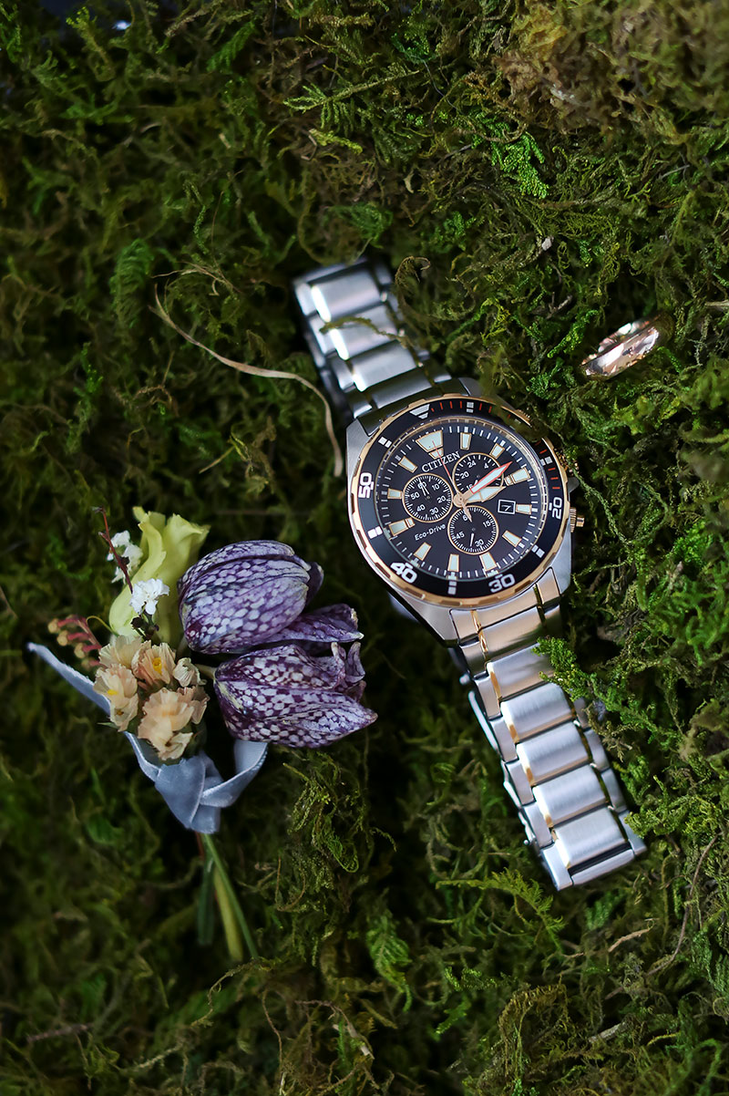 crocus wedding flower next to man's watch on moss