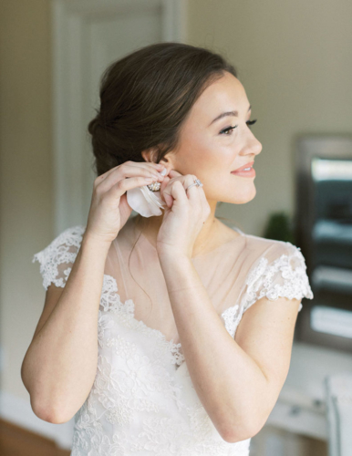 southern wedding country bride putting on earring
