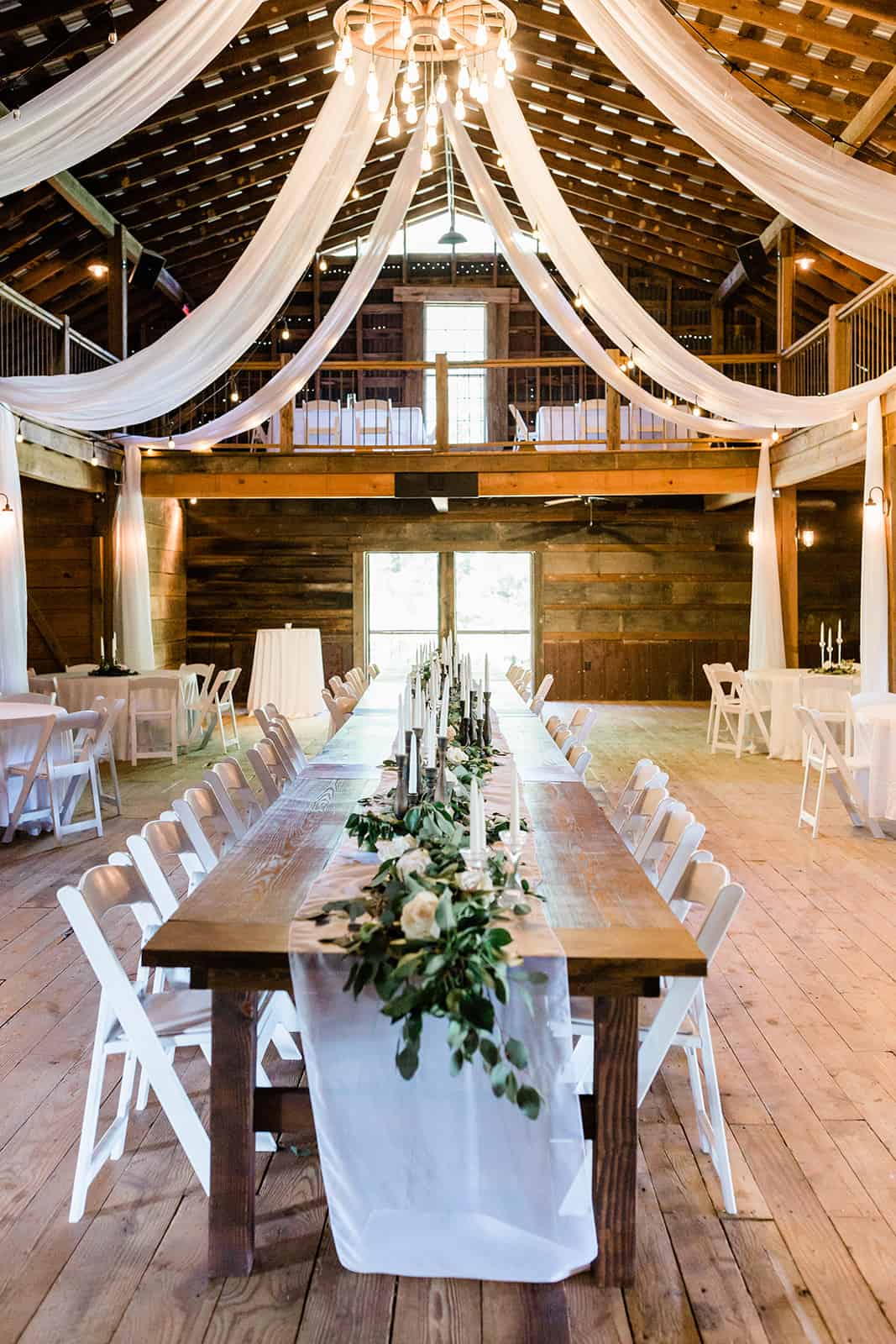 wedding venue rustic barn long central dinner table