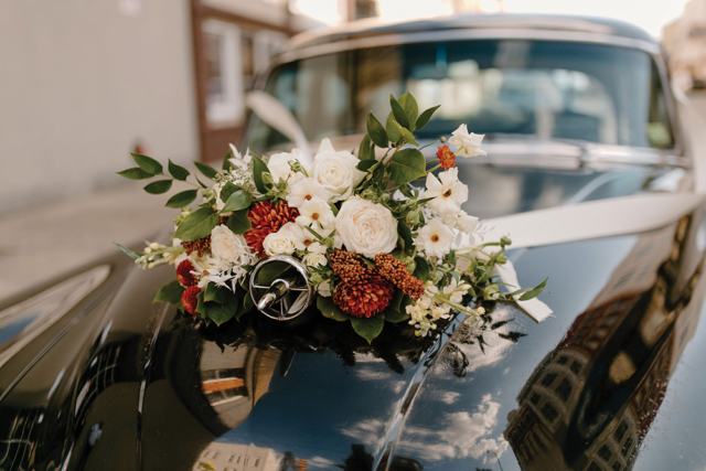 vintage bouquet on hood of vintage car