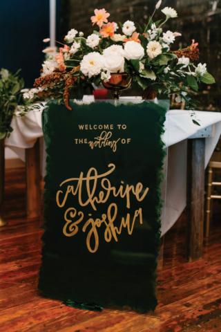 welcome wedding sign hand lettering script emerald green and gold painted on glass