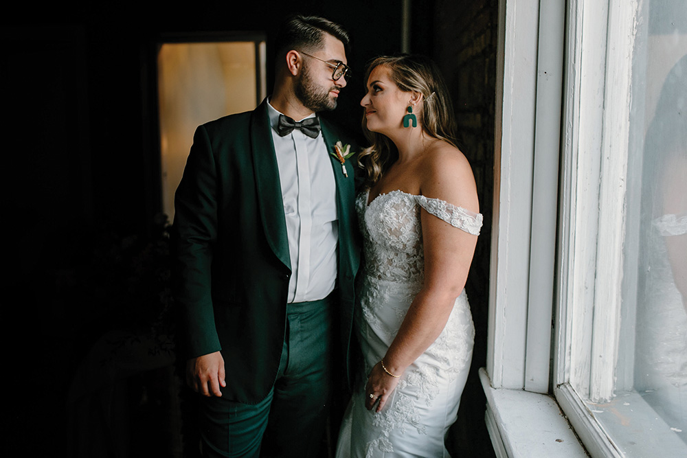 wedding couple emerald green groom suit and bride earrings