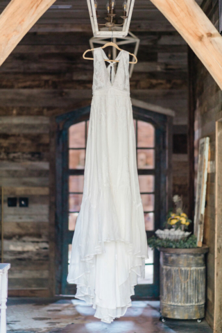 wedding dress hanging in farm chic entrance