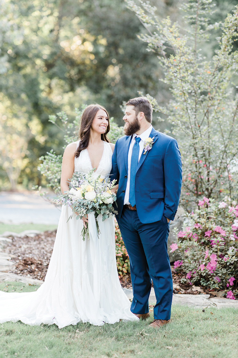 wedding couple navy suit, light yellow and lavender bouquet