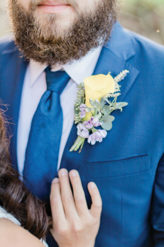 closeup boutonniere navy groom suit yellow flower