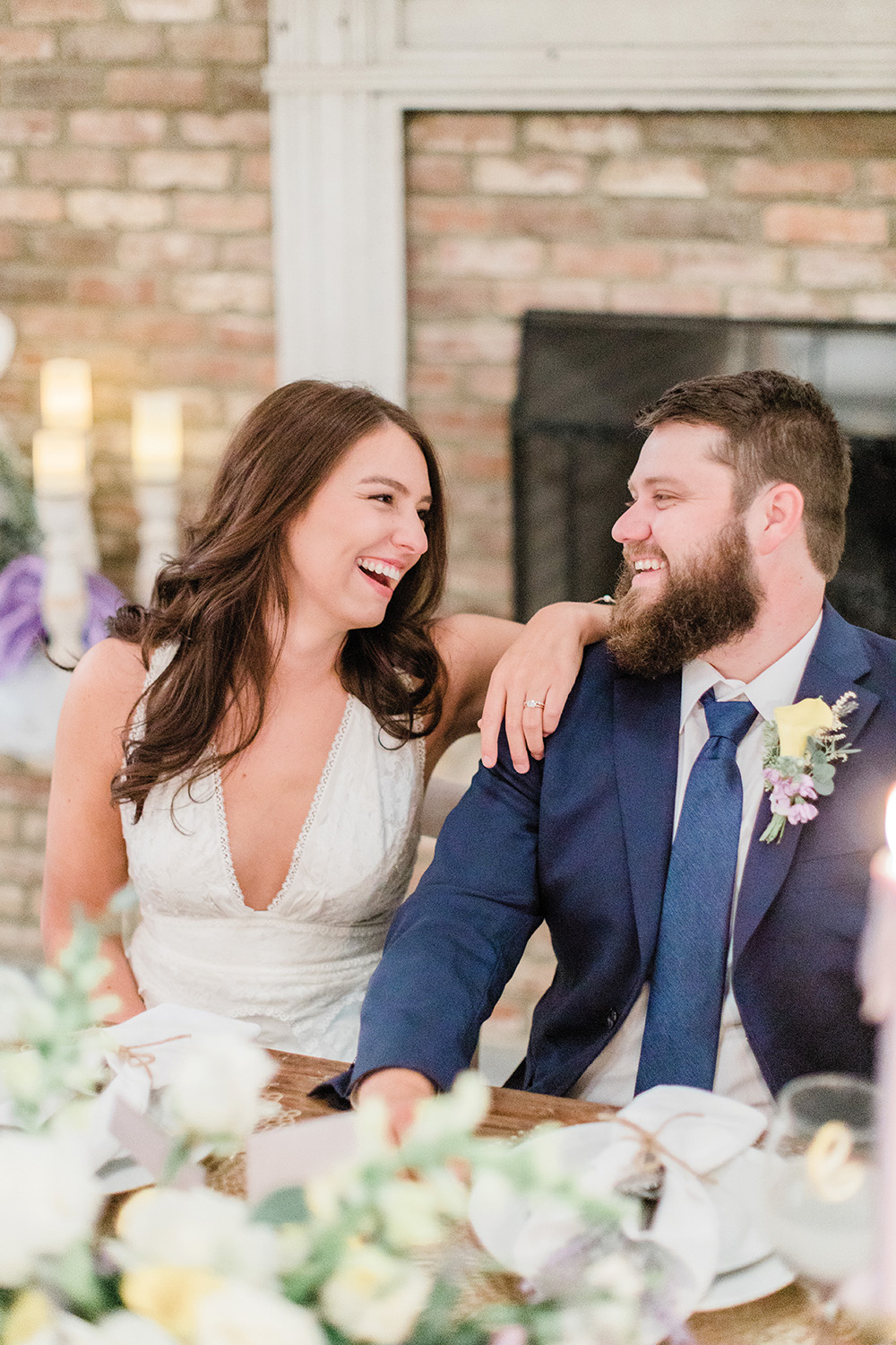 laughing couple at wedding table