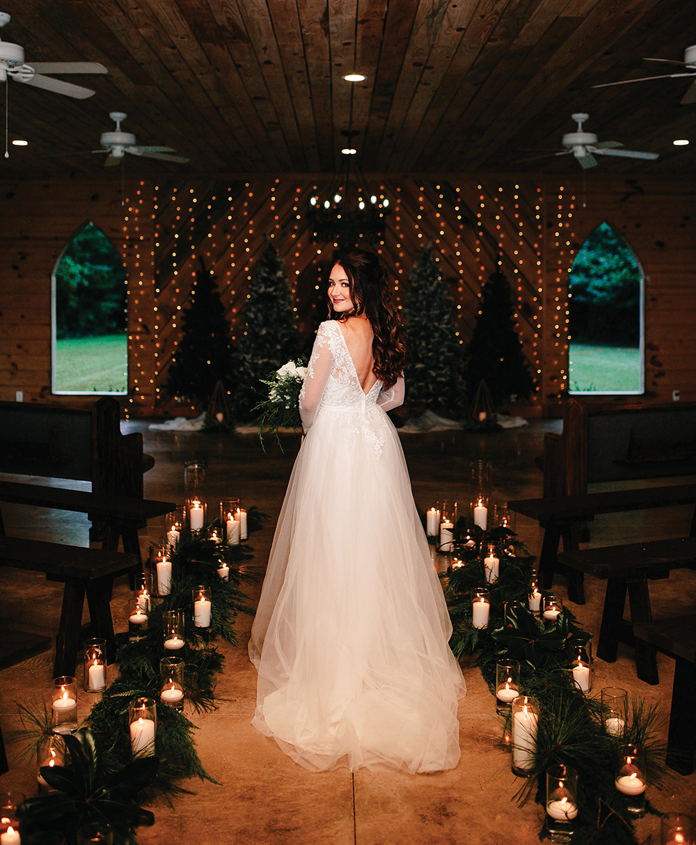winter wedding beautiful bride candlelit chapel pine trees