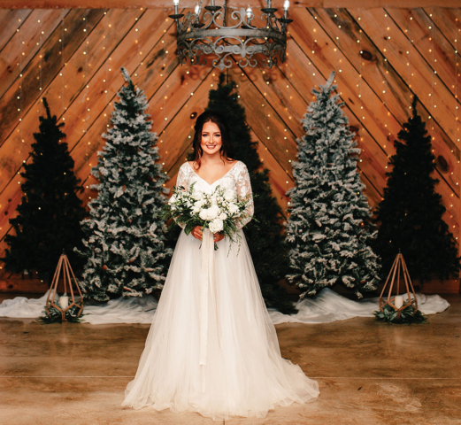 winter wedding beautiful bride candlelit chapel pine trees white bouquet